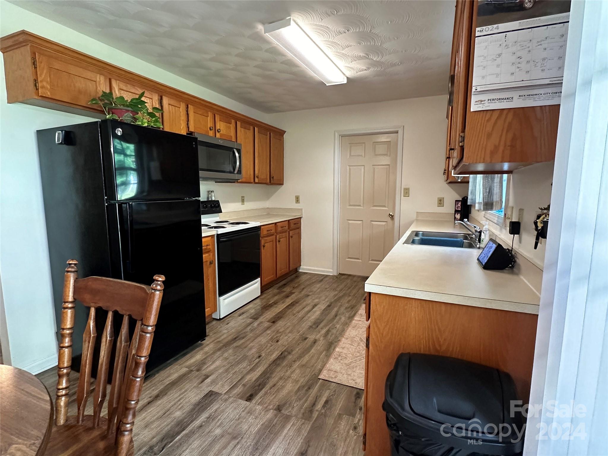 4886 Sandstone Drive Conover, NC 28613 - Photo 3 of 22 a kitchen with stainless steel appliances a stove a refrigerator and a sink