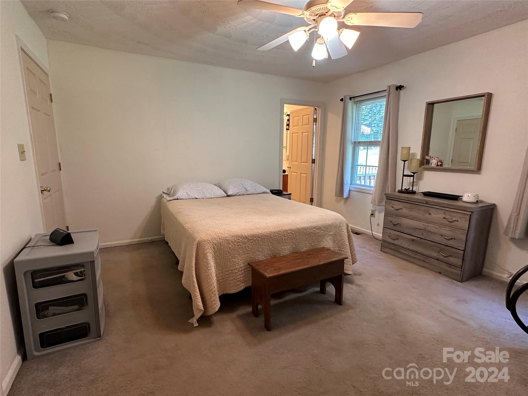 4886 Sandstone Drive Conover, NC 28613 - Photo 8 of 22 a bedroom with a bed and a chandelier