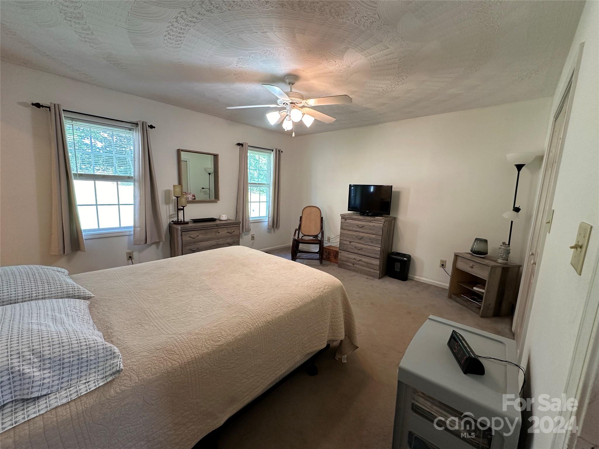 4886 Sandstone Drive Conover, NC 28613 - Photo 9 of 22 a bedroom with a bed and a chandelier