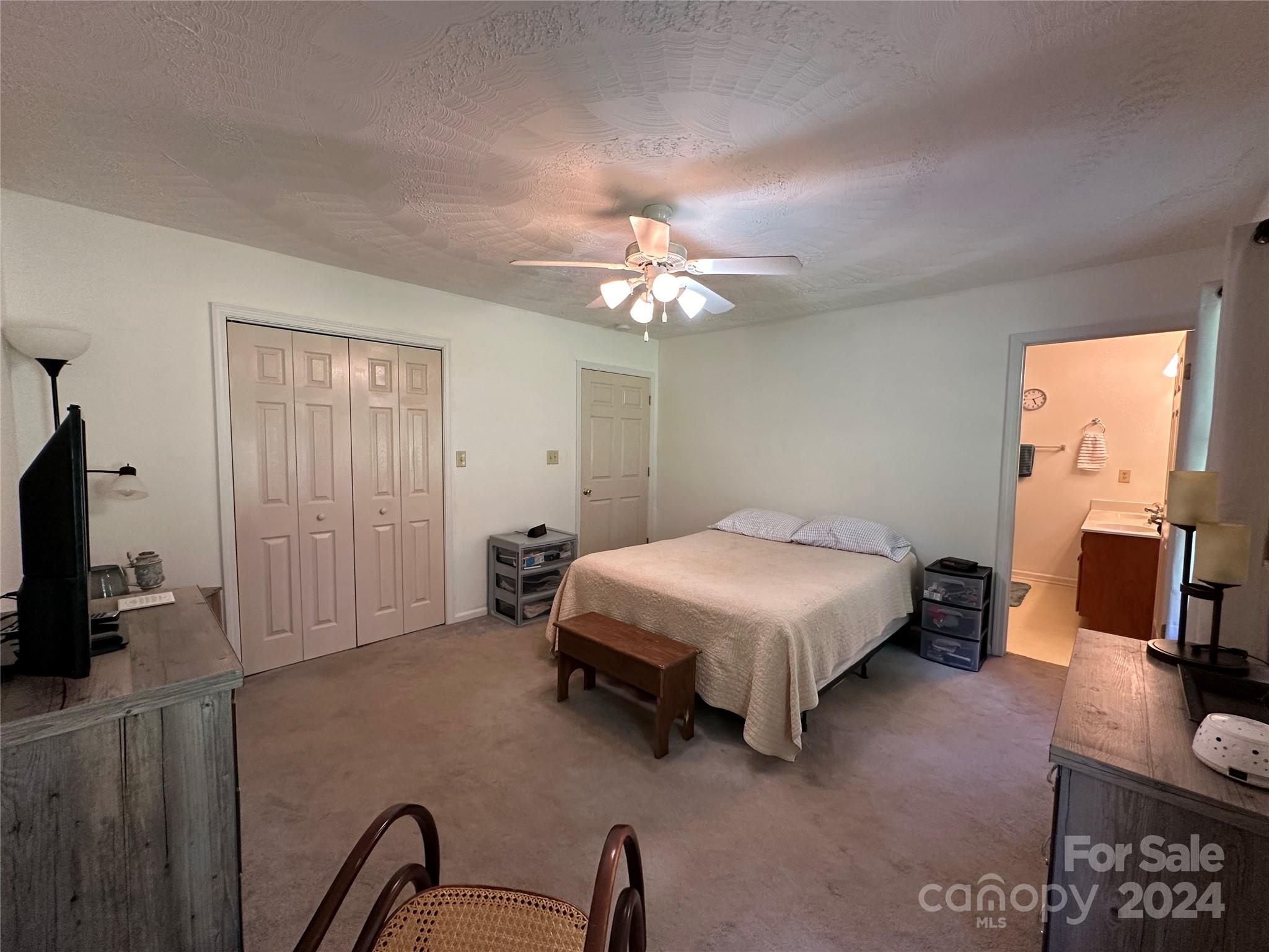 4886 Sandstone Drive Conover, NC 28613 - Photo 10 of 22 a bedroom with a bed a couch and a flat tv screen on the dresser