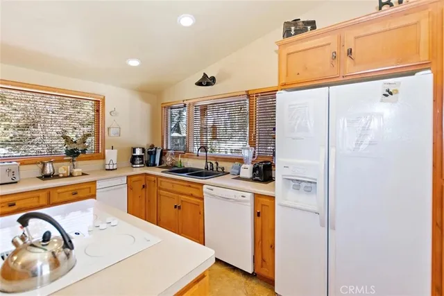 a kitchen with cabinets a sink and appliances