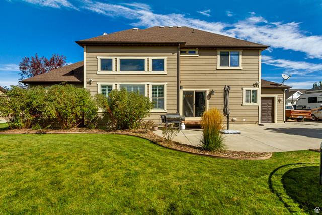 40 Wheeler Road Heber City, UT 84032 - Photo 40 of 41 Expansive backyard with a manicured lawn, concrete patio, and mature shrubbery