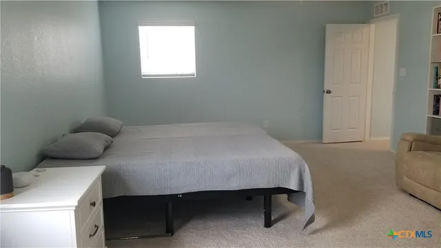 a bedroom with a bed and window