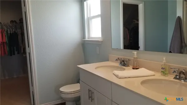 a bathroom with a sink toilet and a mirror