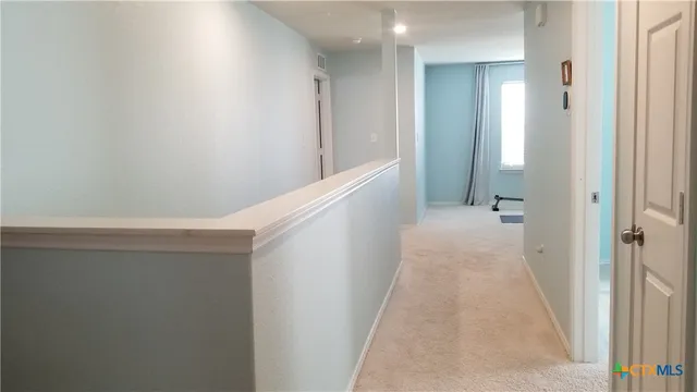 a view of a hallway with white walls