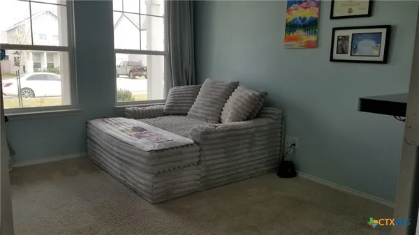 a bed sitting in a bedroom next to a window