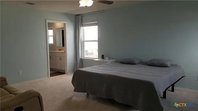 a bedroom with a bed and window