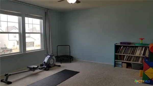 a room with gym equipment and a window