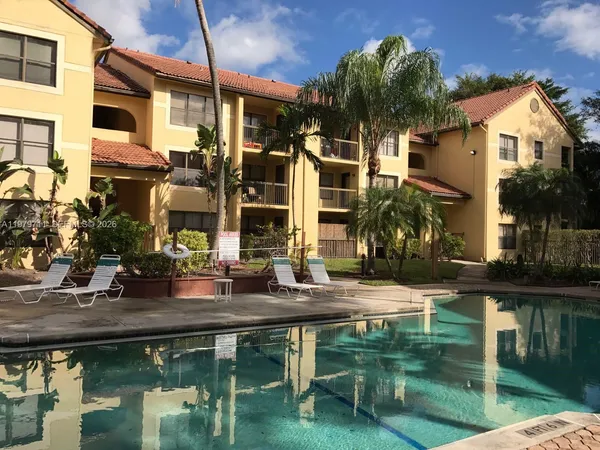 a couple of table and chairs in front of house
