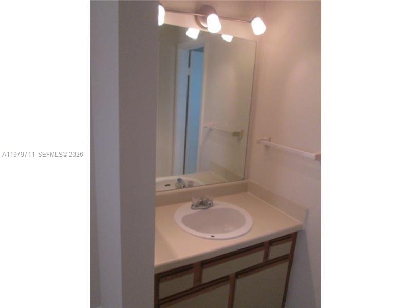 4241 West McNab Road, Unit 30 Pompano Beach, FL 33069 - Photo 6 of 35 a bathroom with a sink and a mirror