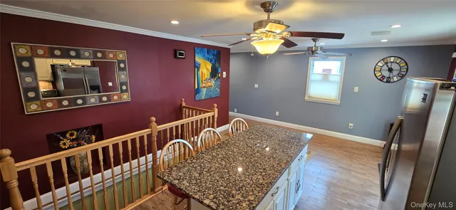 a view of hallway with furniture and wooden floor