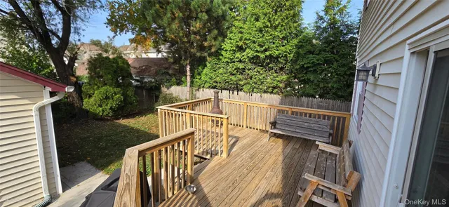 a view of a balcony with wooden floor