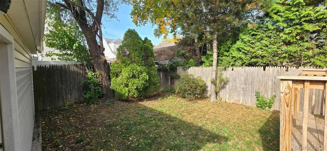 a front view of house with deck and yard