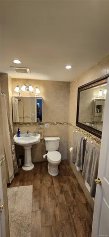 a view of a room with wooden floor and white walls