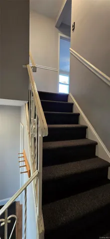 an empty room with closet and a hallway