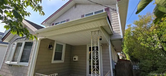 a view of a house with a door and wooden walls