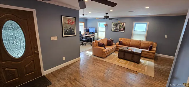 a living room with furniture and a mirror