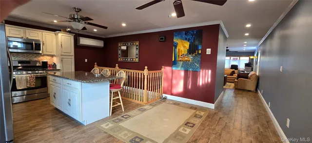 a kitchen with stainless steel appliances granite countertop a stove and a refrigerator