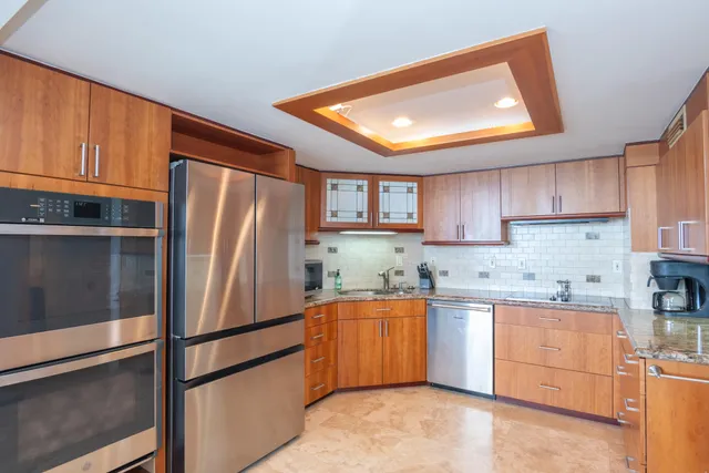 a kitchen with stainless steel appliances granite countertop a refrigerator sink and cabinets