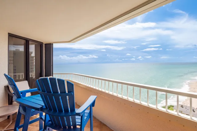 a view of a balcony with furniture