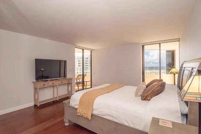 a bedroom with a bed and a flat screen tv