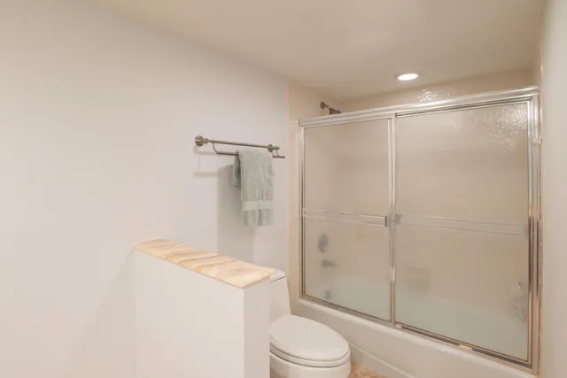 a bathroom with a shower a toilet and sink