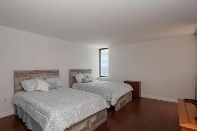 a bedroom with two beds and a night stand