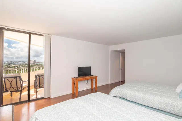 a bedroom with a bed and a large window