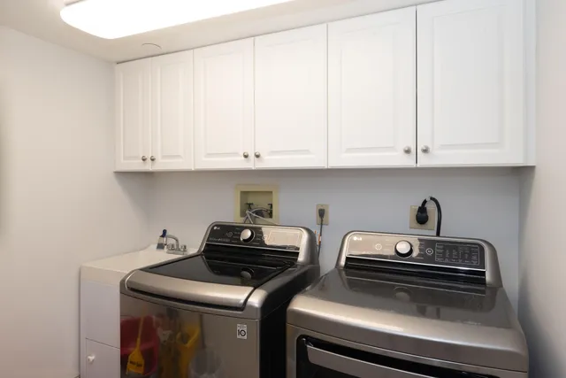 a kitchen with appliances a stove and cabinets