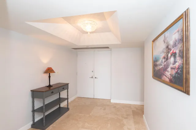 a view of a hallway with paintings on the wall