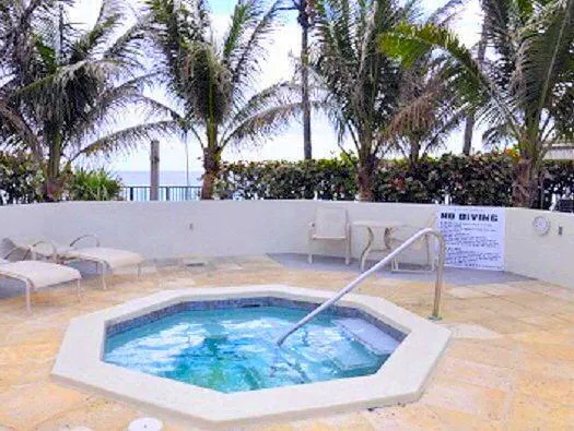 a view of swimming pool with outdoor seating and plants