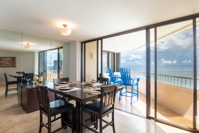 a view of a dining room with furniture and window