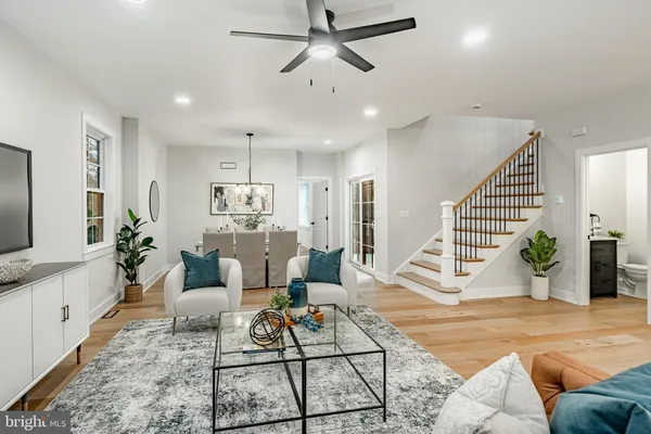 a living room with furniture a mirror and a flat screen tv