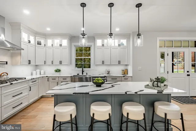 a kitchen with stainless steel appliances a sink stove and cabinets