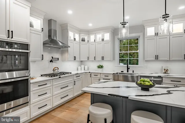 a bathroom with a granite countertop sink mirror vanity and toilet