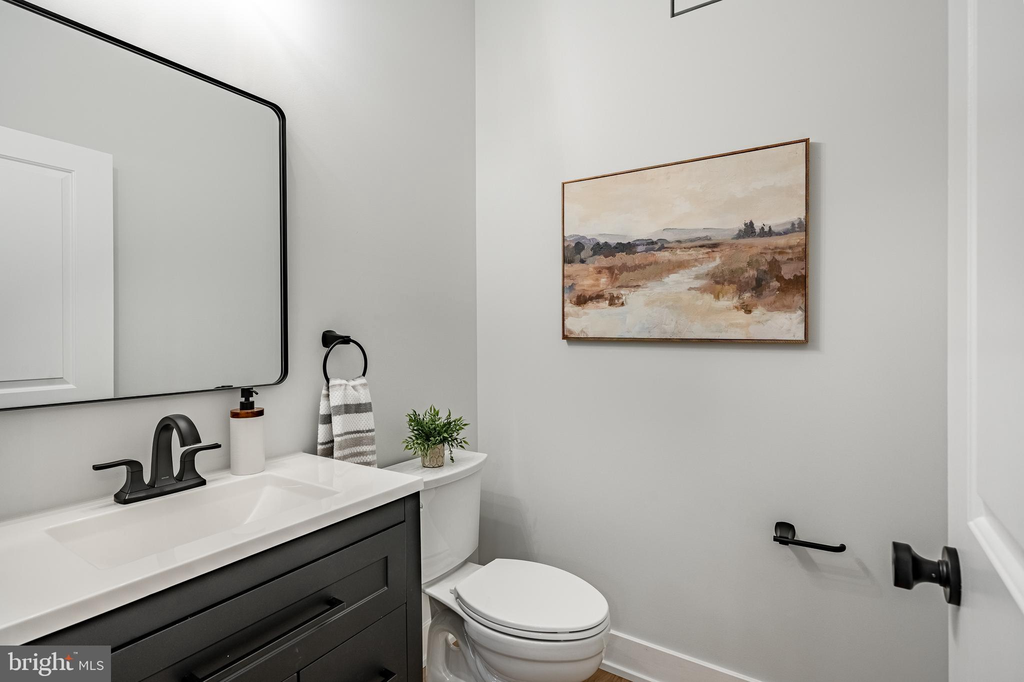 714 South Wayne Street West Chester, PA 19382 - Photo 22 of 62 a bathroom with a granite countertop sink mirror vanity and toilet