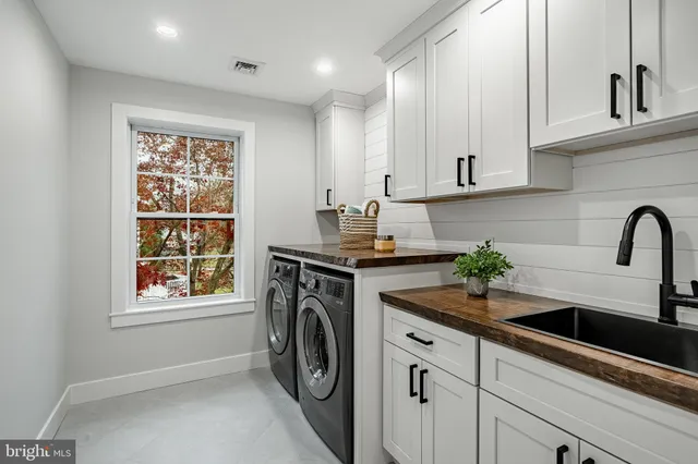 a white bath tub sitting in a bathroom next to a window