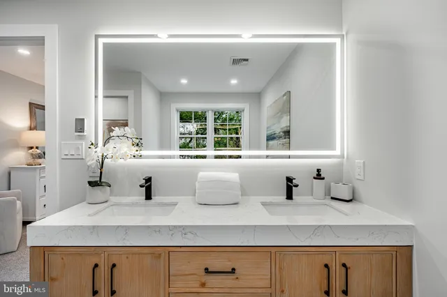 a view of empty room with wooden floor and windows
