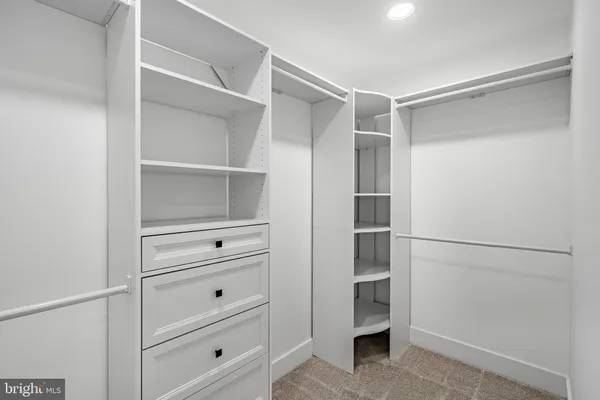 an empty room with windows and ceiling fan