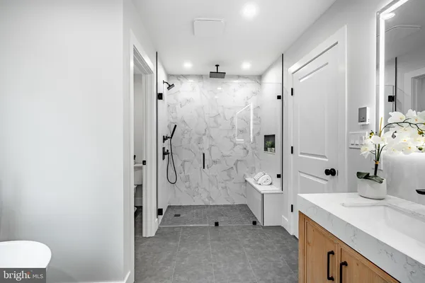 a bathroom with a sink vanity and a mirror