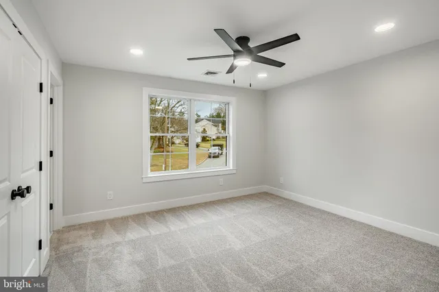 a view of a white house with a yard