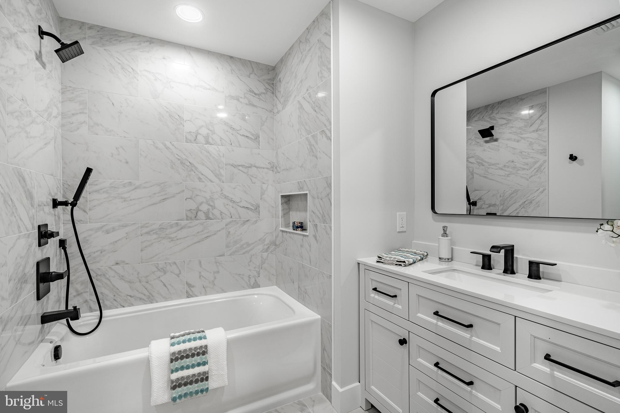 714 South Wayne Street West Chester, PA 19382 - Photo 54 of 62 a bathroom with a bath tub a sink and mirror