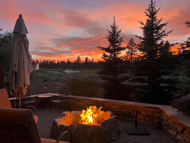 a view of swimming pool from a balcony with furniture
