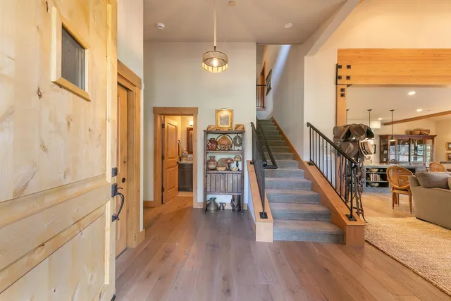 a view of a hallway with wooden floor and staircase