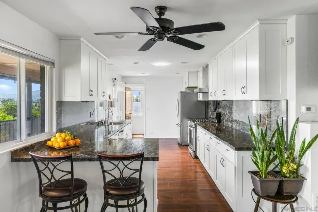 a view of empty room with wooden floor and fireplace