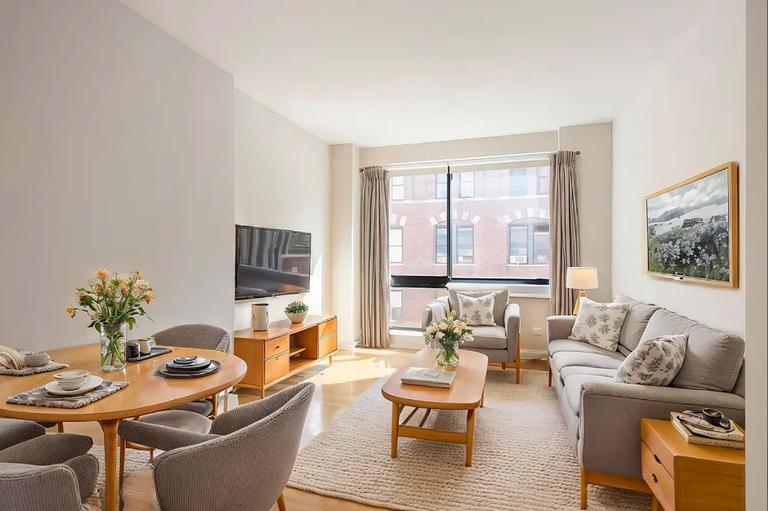 537 West 27th Street, Unit 2F Manhattan, NY 10001 - Photo 1 of 6 a living room with furniture and a flat screen tv
