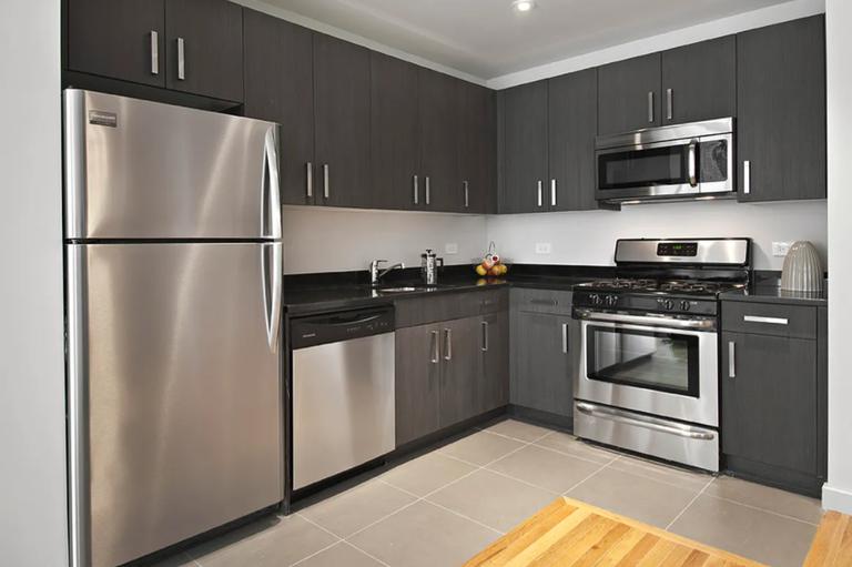 537 West 27th Street, Unit 2F Manhattan, NY 10001 - Photo 3 of 6 a kitchen with a refrigerator stove and microwave