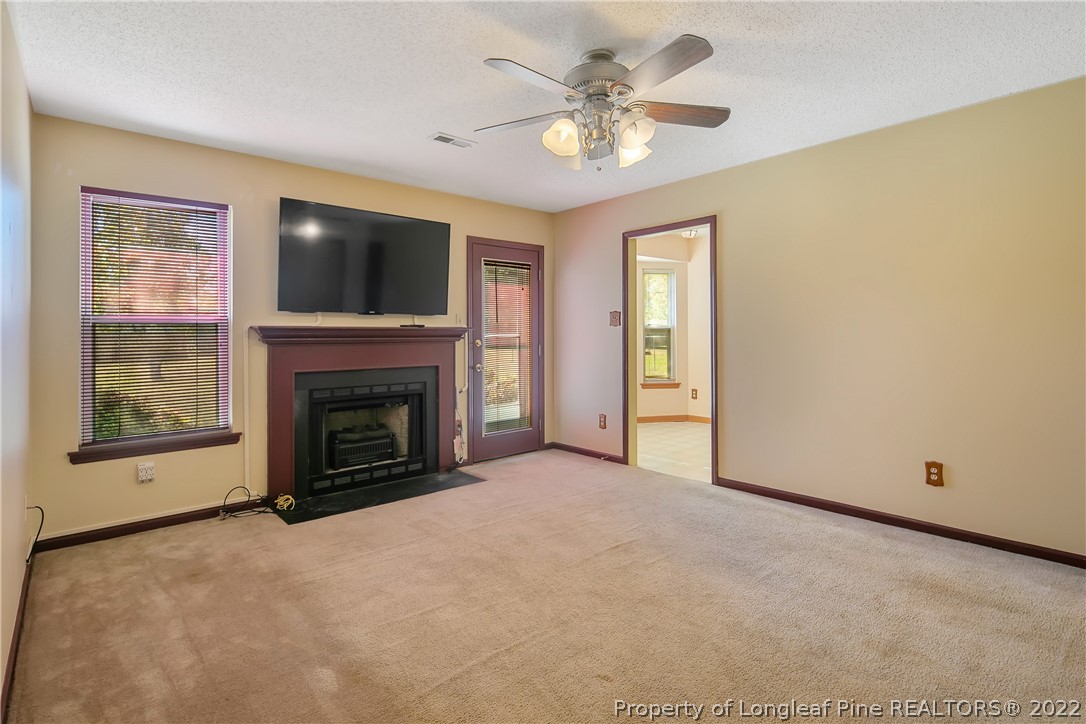 7455 Elliott Bridge Road Spring Lake, NC 28390 - Photo 13 of 49 a view of a livingroom with a fireplace and a flat screen tv