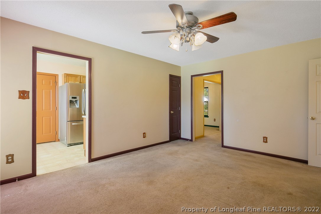 7455 Elliott Bridge Road Spring Lake, NC 28390 - Photo 14 of 49 an empty room with closet and a ceiling fan
