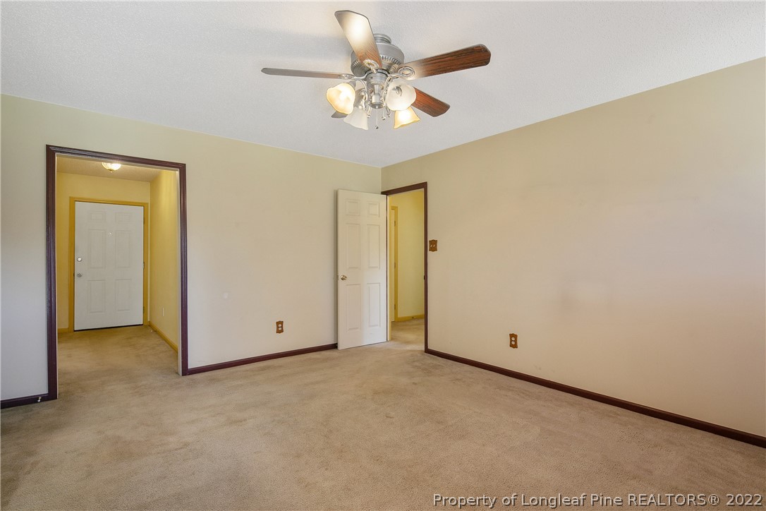7455 Elliott Bridge Road Spring Lake, NC 28390 - Photo 15 of 49 an empty room with a ceiling fan and a window
